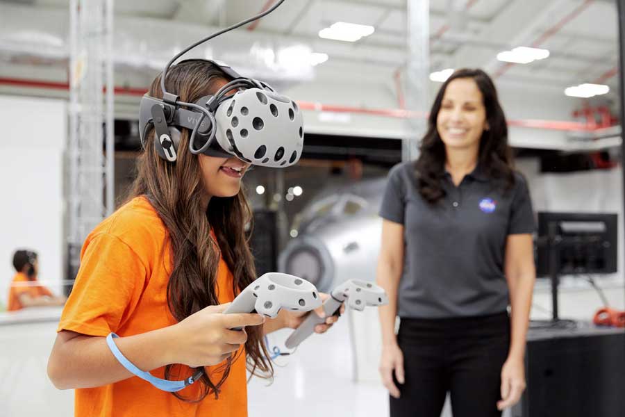 Young girl uses a Virtual Reality headset to walk on Mars.