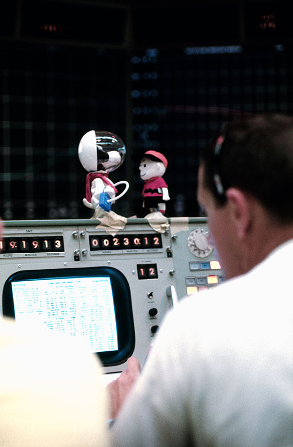Snoopy and Charlie Brown sit atop of a console in the Mission Control Center.