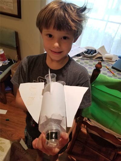Young boy holding his Virtual Camp KSC project