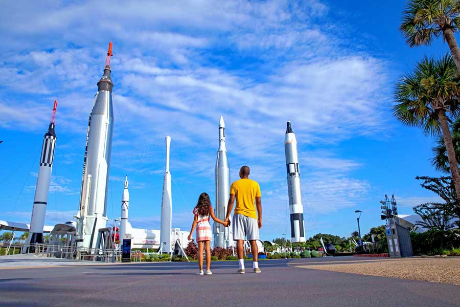 Father and daughter look in awe at the rocket garden at Kennedy Space Center VIsitor Complex.