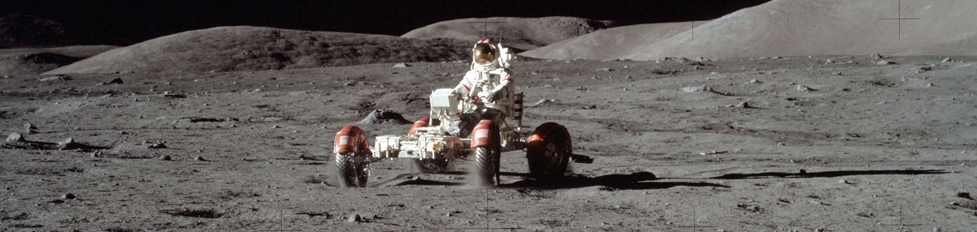 Astronaut Eugene A. Cernan is seen test driving the "stripped down" Lunar Rover Vehicle (LRV) prior to loading the LRV up.