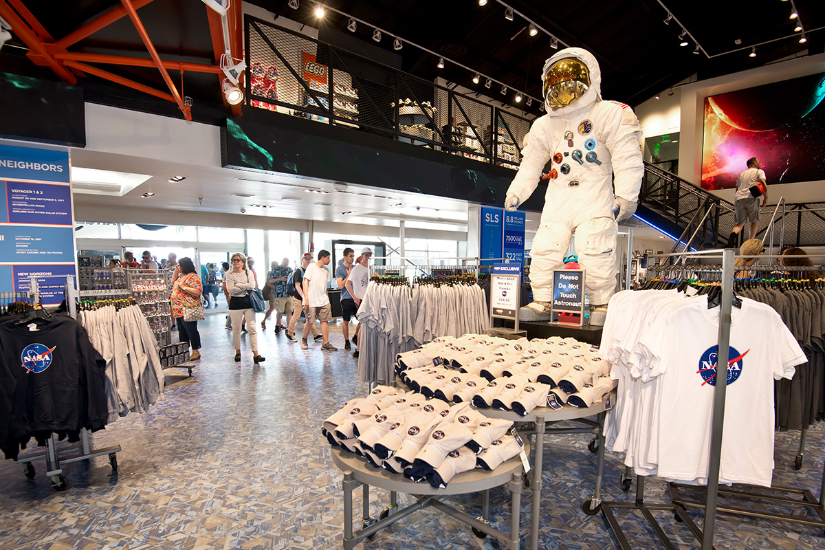 Interior of the Space Shop, with NASA clothing and gifts on display.