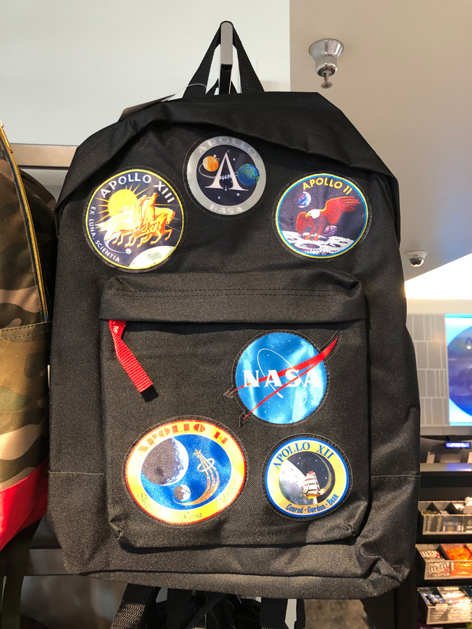Backpack with various mission patches on it.