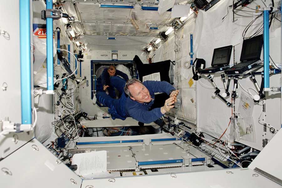 This STS-98 mission photograph shows astronauts Thomas D. Jones (foreground) and Kerneth D. Cockrell floating inside the newly installed Laboratory aboard the International Space Station (ISS).