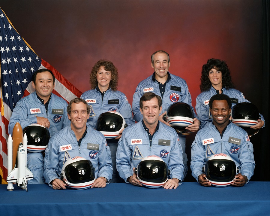 Challenger STS-51L Crew (left to right, front row) astronauts Michael J. Smith, Francis R. (Dick) Scobee and Ronald E. McNair; Ellison S. Onizuka, Sharon Christa McAuliffe, Gregory Jarvis and Judith A. Resnik. McAuliffe and Jarvis are payload specialists, representing the Teacher in Space Project and Hughes Company, respectively.