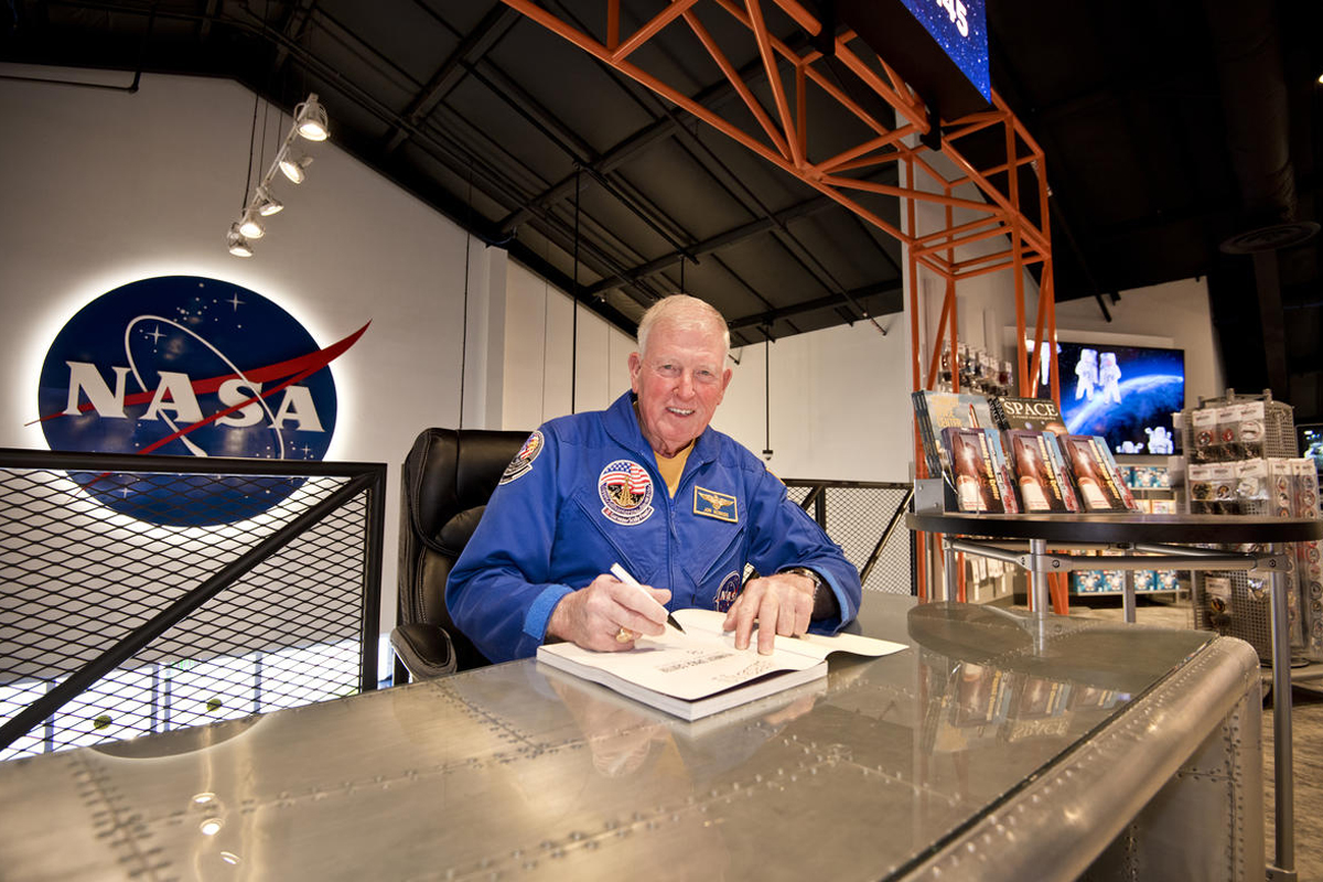 Astronaut Jon McBride signing autographs in The Space Shop