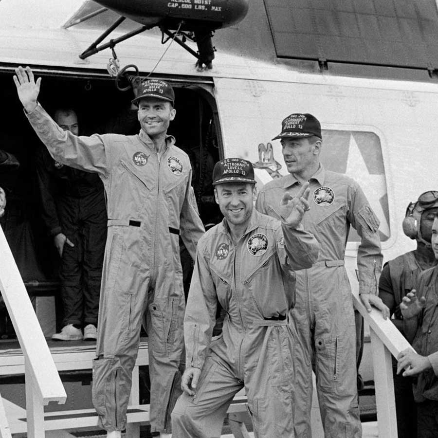 The crewmembers of the Apollo 13 mission, step aboard the USS Iwo Jima, prime recovery ship for the mission, following splashdown and recovery operations in the South Pacific Ocean. Exiting the helicopter which made the pick-up some four miles from the Iwo Jima are (from left) astronauts Fred W. Haise Jr., lunar module pilot; James A. Lovell Jr., commander; and John L. Swigert Jr., command module pilot.