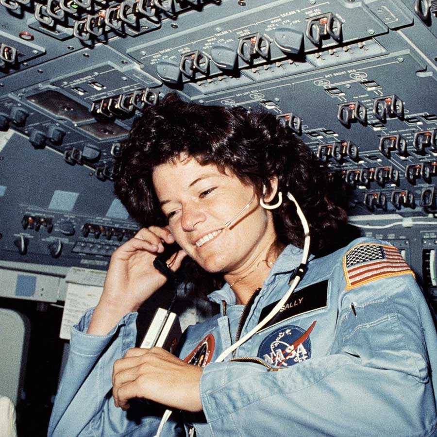Astronaut Sally K. Ride, STS-7 mission specialist, communicates with ground controllers from the flight deck of the Earth-orbiting Space Shuttle Challenger.
