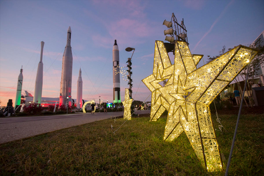 Festive star-shaped lights sit in the Rocket Garden at Kennedy Space Center Visitor Complex.