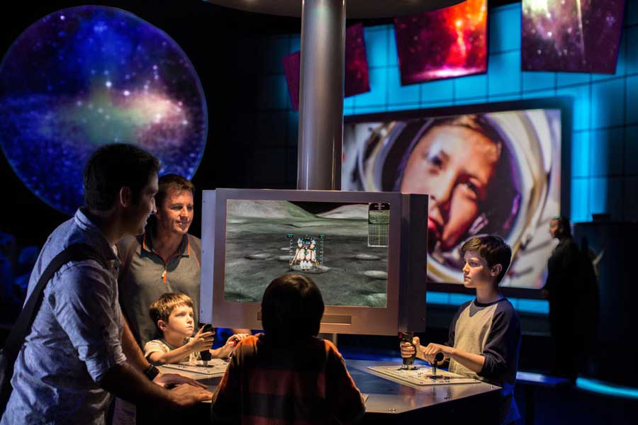 Family interacts with Mars simulator.