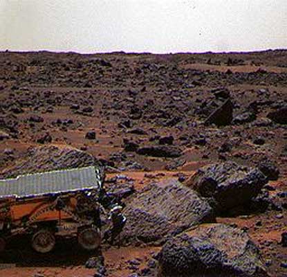 This color image shows the Sojourner rover's Alpha Proton X-ray Spectrometer (APXS) deployed against the rock 'Moe' on the morning of Sol 65.