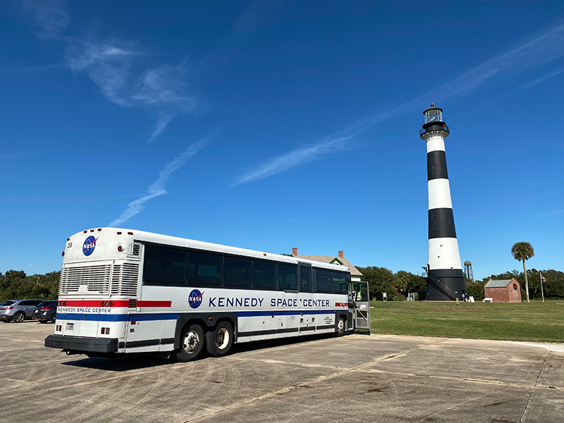 The Cape Canaveral Lighthouse and a Kennedy Space Center Visitor Complex bus.
